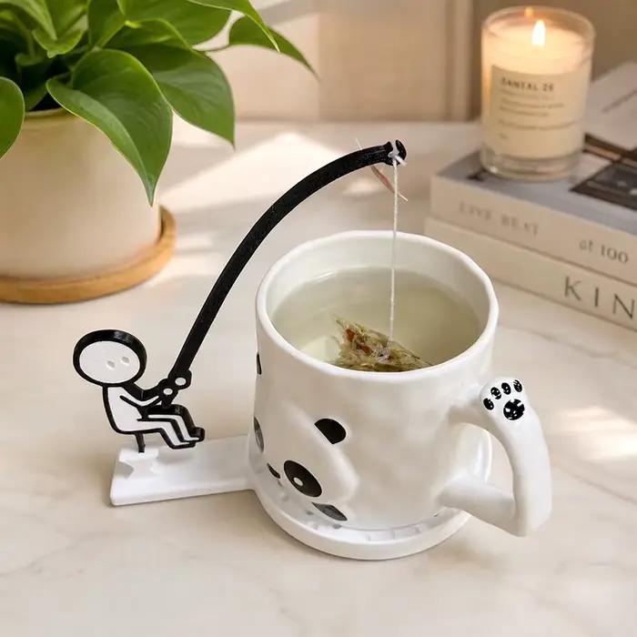 Support de sachet de thé en forme de pêcheur, dessin animé amusant, dessous de tasse bleu ciel pour une pause café unique et durable